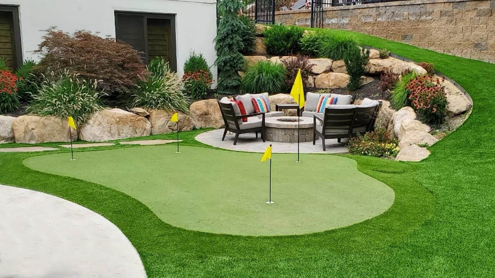 Putting in an artificial putting green is a creative landscape design and construction idea.
